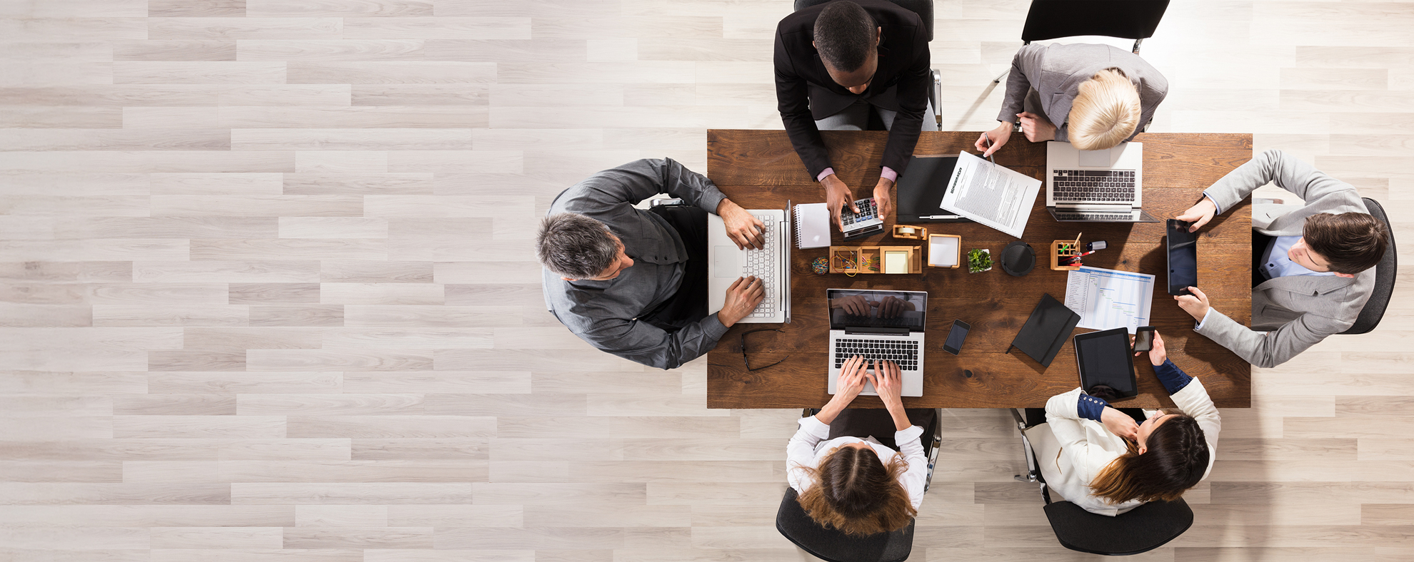 Overhead shot of people working at table for Careers page banner.